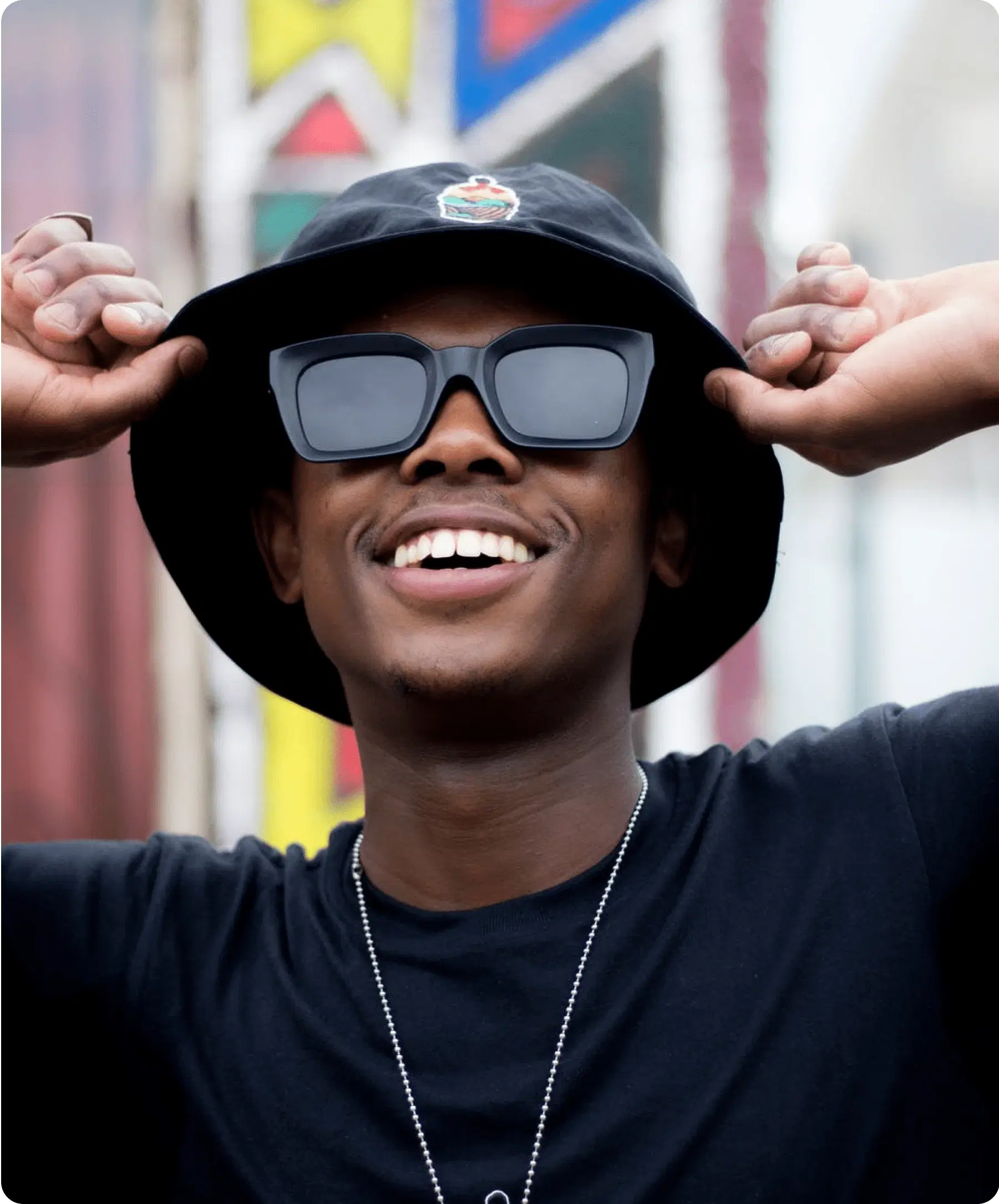 Smiling man in a bucket hat.